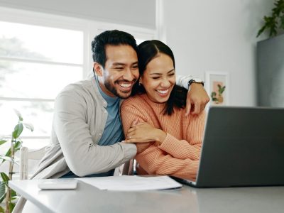 Happy,Couple,,Paperwork,And,Hug,With,Laptop,For,Budget,,Paying